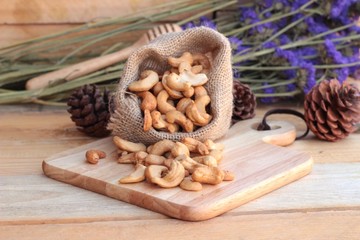Roasted cashews nuts with natural on wood background
