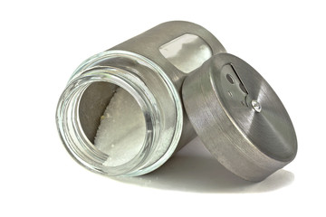 Salt shaker,  jar with salt,lying on its side.Isolated.