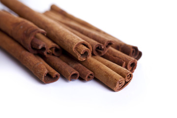 Cinnamon sticks shot on a white background at an angle