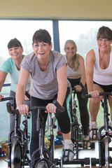 Fototapeta premium Senior women using spinning bikes