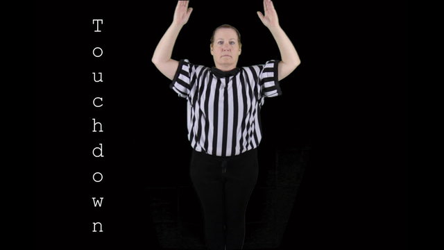 Woman dressed as a football referee signaling Touchdown.