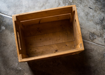 Empty wodden box on polished cement floor