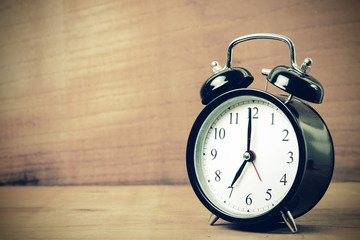 Retro alarm clock with wood background  