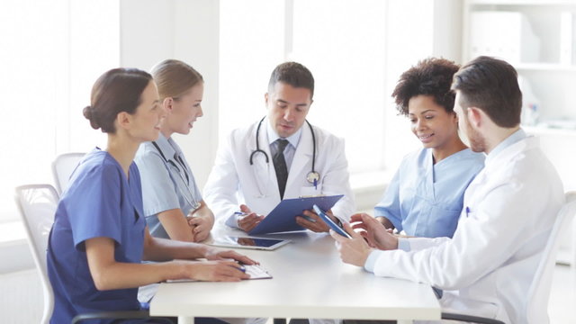 group of happy doctors meeting at hospital office