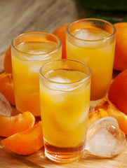 Freshly squeezed apricot juice with ice, selective focus