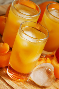 Freshly squeezed apricot juice with ice, selective focus