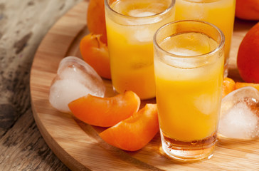 Freshly squeezed apricot juice with ice, selective focus