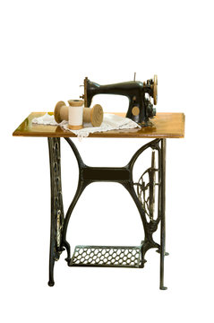 The old sewing machine on a white background