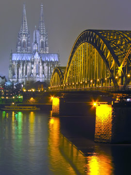 Cologne Cathedral and iron Bridge at night in Cologne, Germany