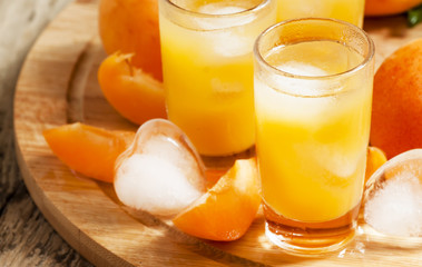 Freshly squeezed apricot juice with ice, selective focus