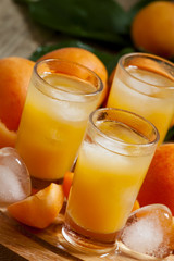 Freshly squeezed apricot juice with ice, selective focus