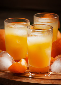 Freshly squeezed apricot juice with ice, selective focus