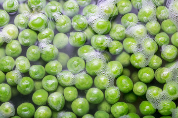 Green peas being boiled in a pot