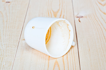empty dirty cup of coffee lying on the boards