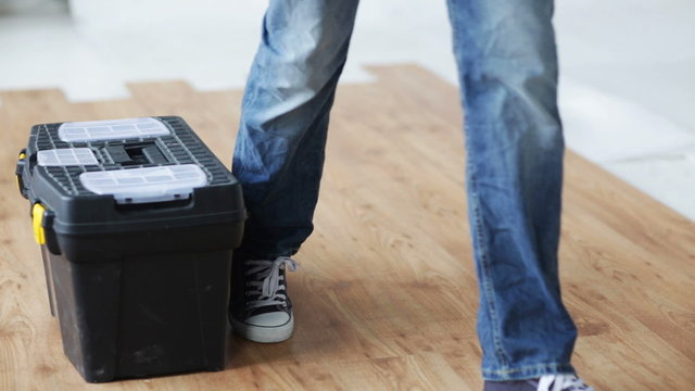 close up of man carrying tool box and leaving it