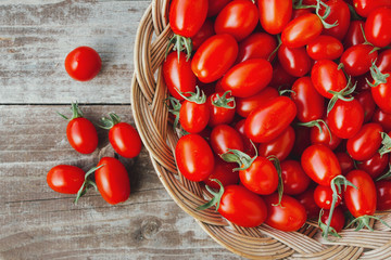 Organic red cherry tomatoes on a wooden board