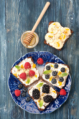 Sweet sandwich with berries, fruit, cream cheese, chia seeds and honey. healthy breakfast. Top view