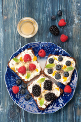 Sweet sandwich with berries, fruit, cream cheese, chia seeds and honey. healthy breakfast. Top view