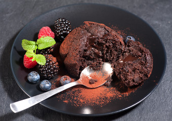 Chocolate muffin with chocolate cream and berries