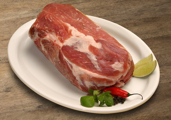 Raw meat selection on wooden cutting board with knife