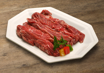 Raw meat selection on wooden cutting board with knife