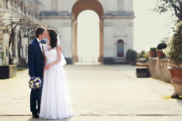 tender romantic curly brunette bride and  stylish groom on the b