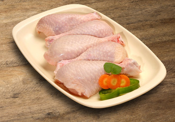 Fresh chicken parts, wings, legs, meat in ice cube trays.