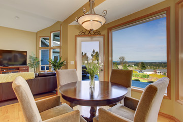 Simplistic dinning area with great view, and light toned hardwoo