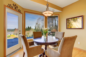 Simplistic dinning area with great view, and light toned hardwoo