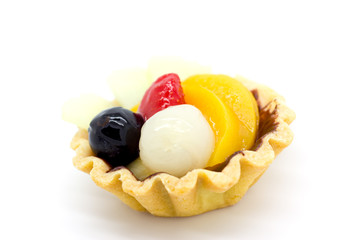 closeup of a glazed fruit tart on a white background