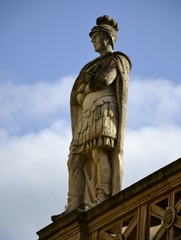 Old statues from Bath and background 