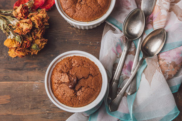 Choco muffins served on a wooden table in white cups