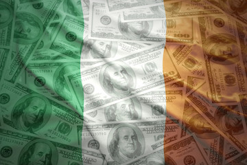 colorful waving irish flag on a american dollar money background - obrazy, fototapety, plakaty