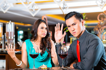 Asian Couple quarelling in restaurant