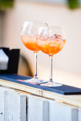 Glasses with tropical cocktail/Two tropical cold cocktail with ice cubes on the bar
