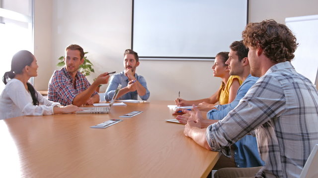 Business people speaking together during meeting 