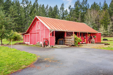 Fototapeta na wymiar Authentic red barn with supplies.