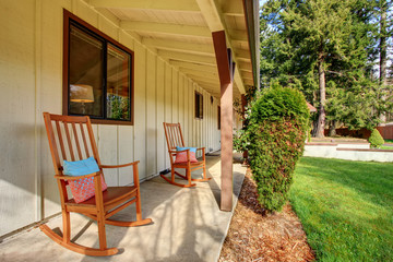 Simple little front porch with two rocking chairs.