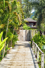 Wooden bridge to the entrance to the villa of resort.