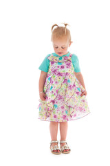 Shy toddler girl in summer dress