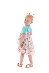 Toddler girl dancing in summer dress