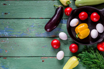 Summer vegetables on green wooden table.