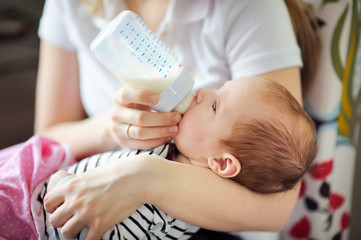 Baby drinking milk from bottle