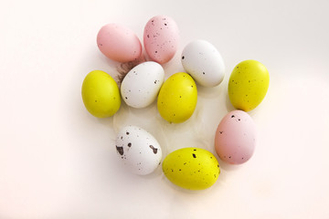 Colourful Easter eggs with spots on shot from above on a white background 