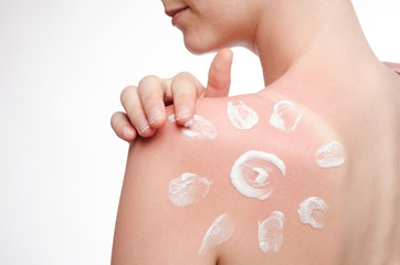 sunblock on the shoulder of a young woman