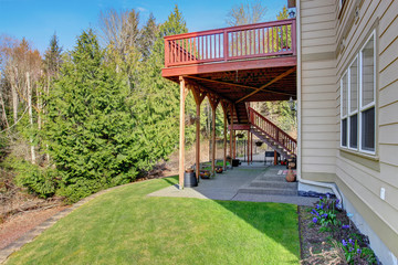 Nice back porch with covered patio and decor.