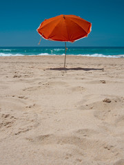 Orange parasol on the beach