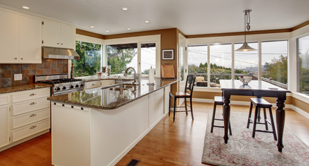 Brilliant kitchen with white accents, and marble counters.