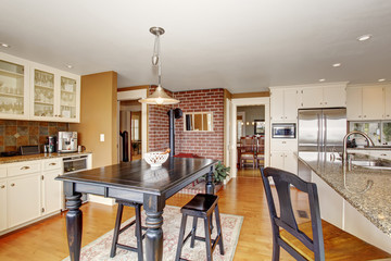 Traditional dinning room with hardwood floor, and hanging light