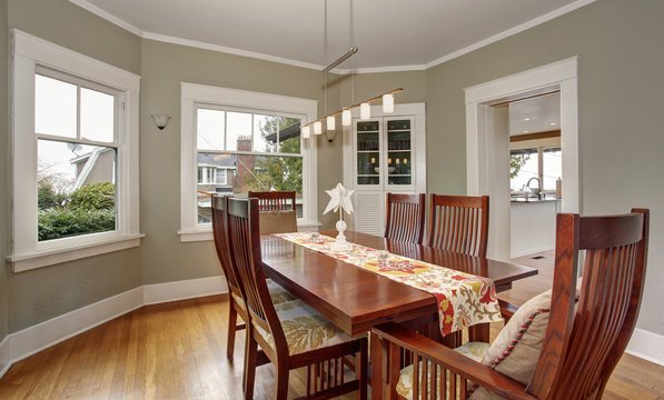 Traditional dinning room with hardwood floor, and hanging light
